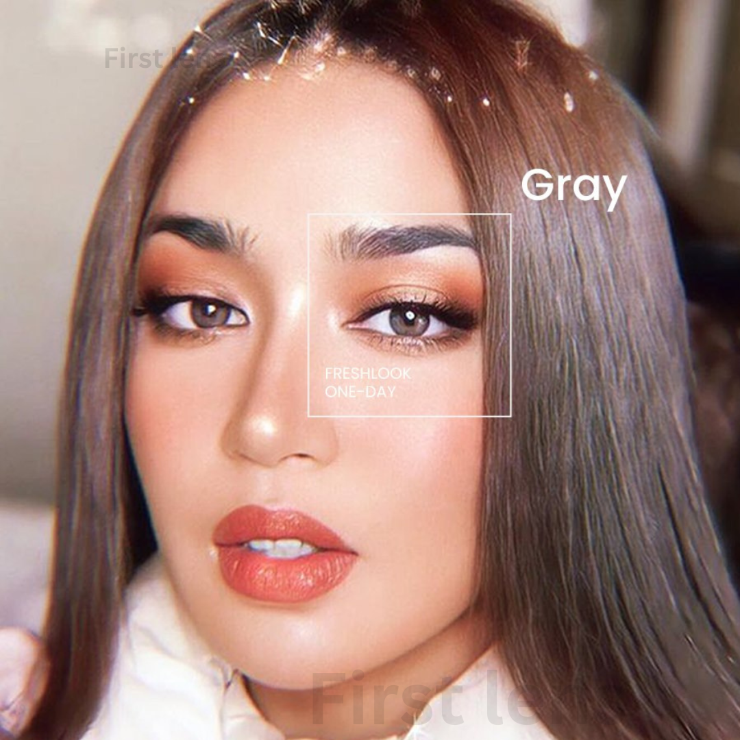A close-up image of the Lens21 Alcon Freshlook OneDay Color Lenses in Grey, with the lenses held up against a bright background, capturing the captivating color.